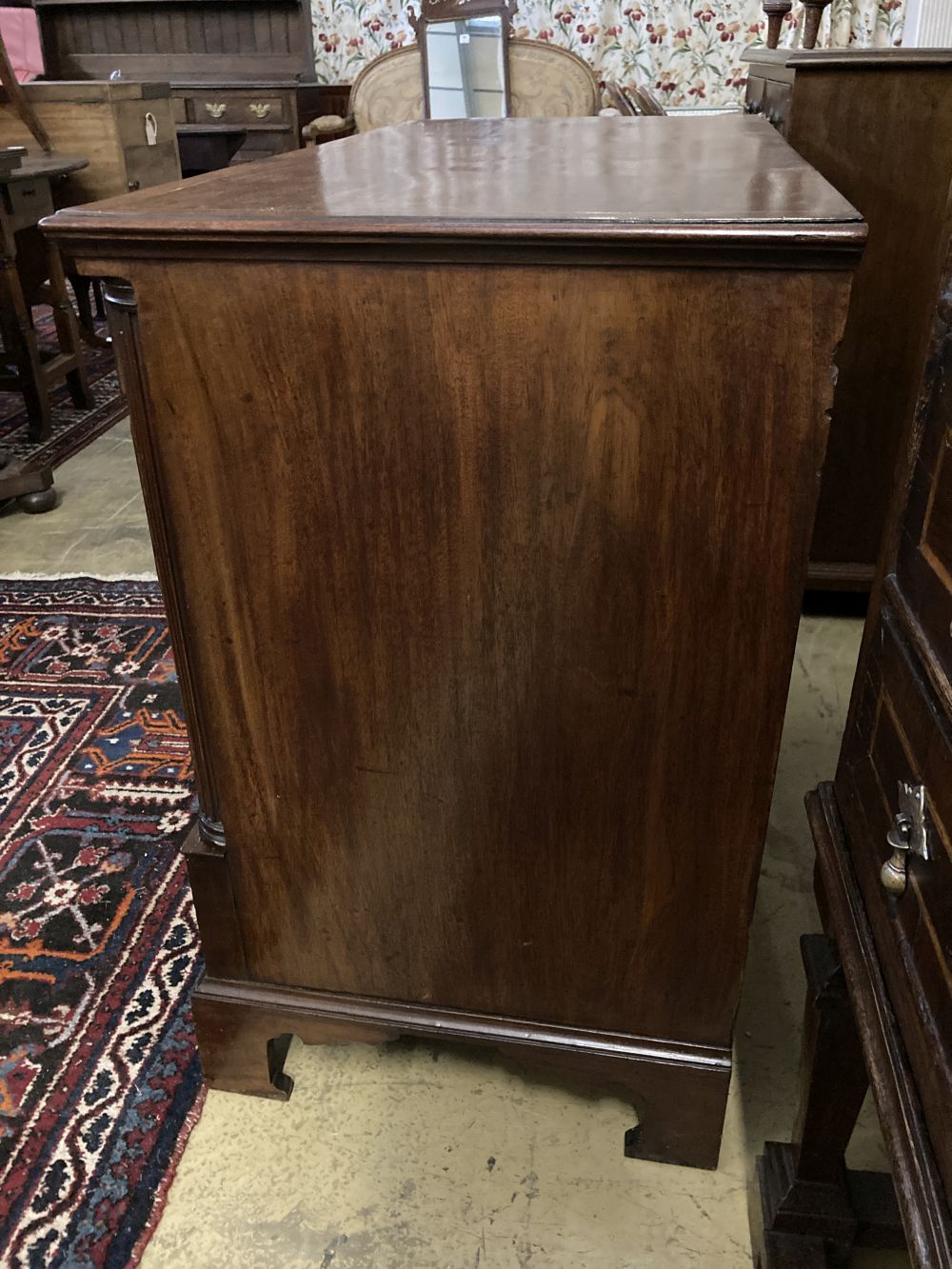 A George III satinwood strung mahogany chest with fluted column canted angles, width 104cm, depth 50cm, height 84cm